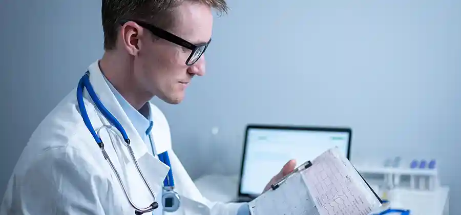 Medical professional reviewing birth records in context of a birth injury caused by medical negligence or malpractice