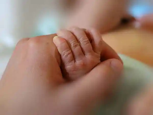 Medical professional explaining the difference between birth injury and birth defect to a family