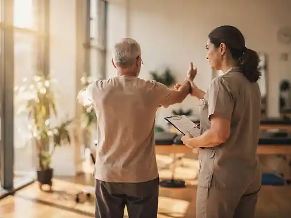 Adult with cerebral palsy working with a physical therapist on mobility and strength