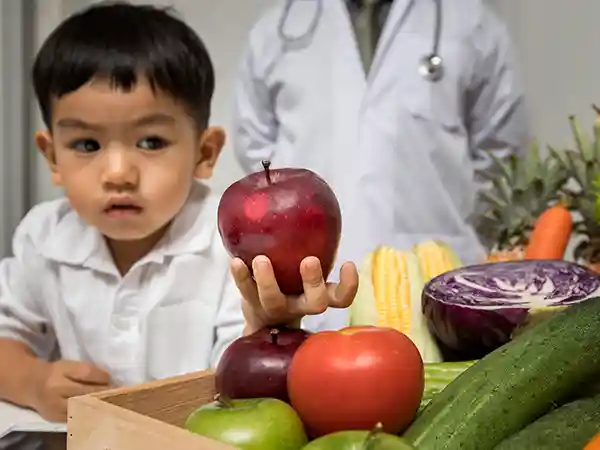 Pediatric nutritionist reviewing dietary options for a child with cerebral palsy
