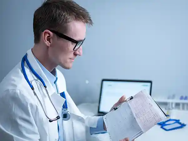 Medical professional reviewing birth records in context of cerebral palsy caused by medical negligence