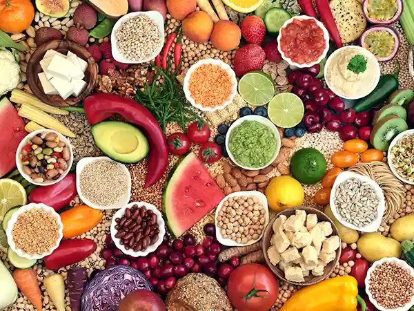 Plant-based foods including berries legumes leafy greens and whole grains that support cerebral palsy nutrition